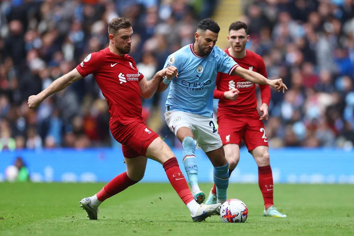 Liverpool's Jordan Henderson (left) in action against Manchester City's Riyad Mahrez during the game at the Etihad. 