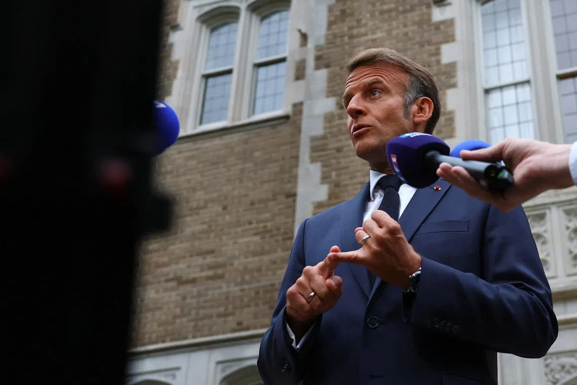 French President Emmanuel Macron speaks with the media after a meeting with U.S. President Donald Trump, Ukrainian President Volodymyr Zelenskiy and European leaders, amid negotiations to end the Russian war in Ukraine, at the French Embassy in Washington, D.C., U.S., August 18, 2025. REUTERS/Yves Herman/Pool/File Photo