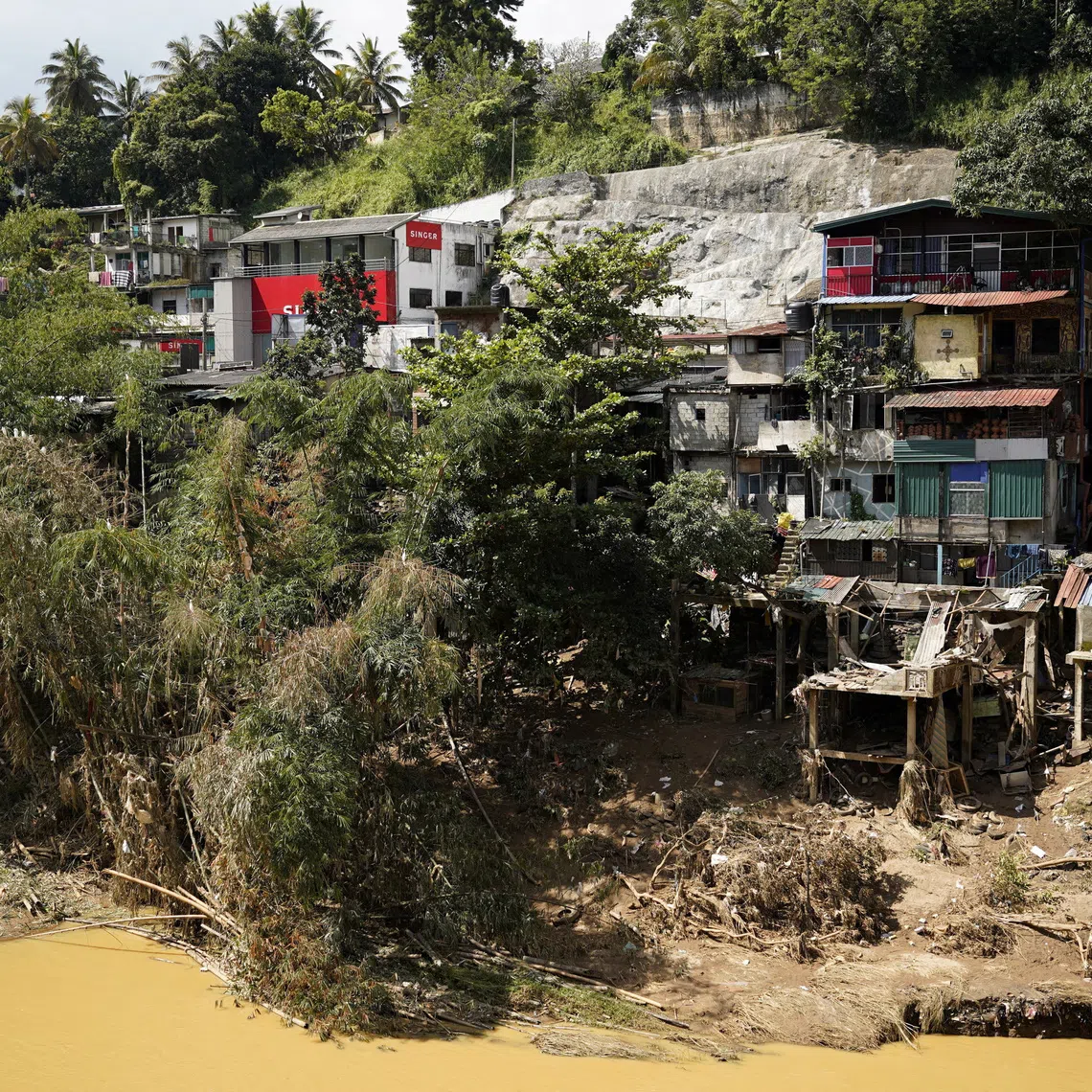 Houses damaged by the overflowing Mahaweli River following Cyclone Ditwah, in Kandy, Sri Lanka, December 4, 2025. REUTERS/Akila Jayawardena
