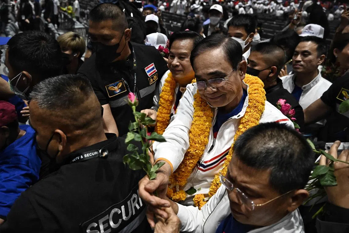 Thai PM Prayut Chan-o-cha receiving flowers from supporters at the Queen Sirikit National Convention Center in Bangkok on Jan 9, 2023.