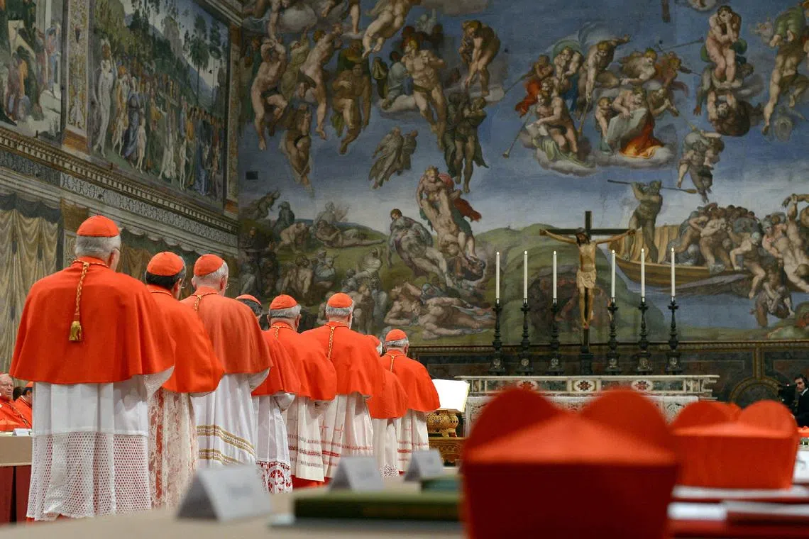 FILE PHOTO: Cardinals enter the Sistine Chapel - which has Michelangelo's soaring Last Judgment on one wall - to begin the conclave in order to elect a successor to Pope Benedict March 12, 2013. REUTERS/Osservatore Romano/File Photo