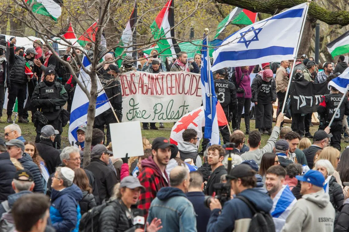 Police stand between counter-protesters and a protest encampment in support of Palestinians, during the ongoing conflict between Israel and the Palestinian Islamist group Hamas, at McGill University’s campus in Montreal, Quebec, Canada May 2, 2024. REUTERS/Peter McCabe