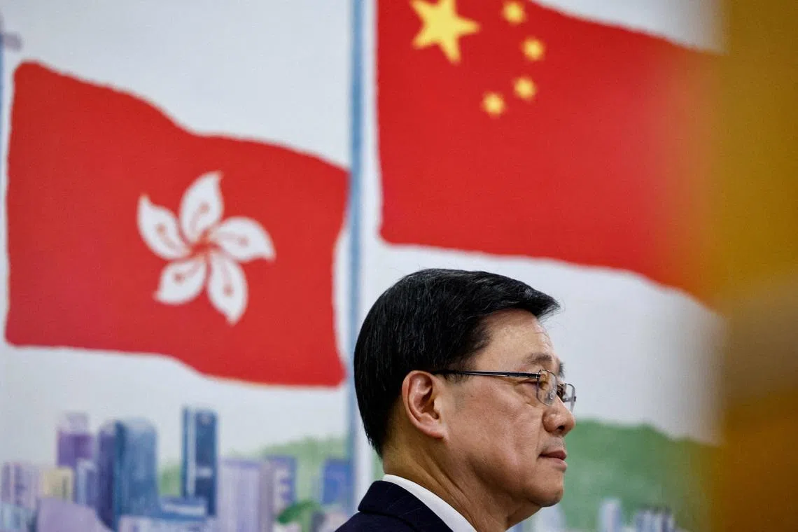 FILE PHOTO: Chief Executive of Hong Kong John Lee attends a press conference in Beijing, China December 16, 2025. REUTERS/Tingshu Wang/File Photo