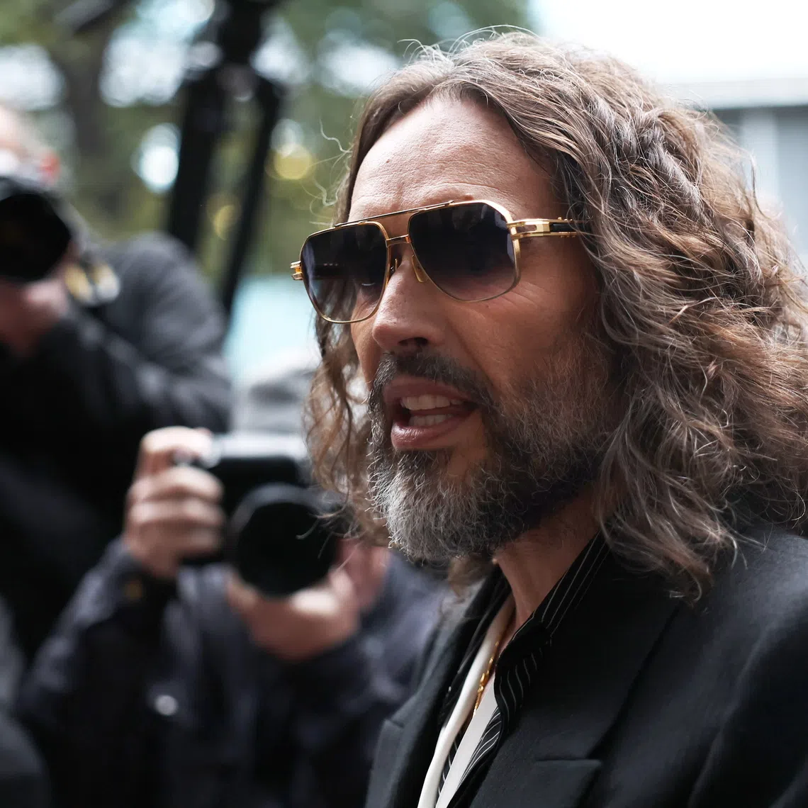 British comedian and actor Russell Brand arrives at Southwark Crown Court in London on Oct 14.