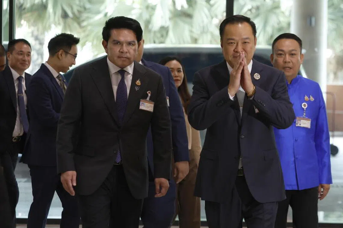 The leader of the Bhumjaithai Party, Anutin Charnvirakul (right) arrives at Parliament in Bangkok, on Sept 3, 2025.
