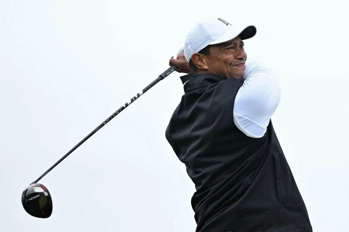 (FILES) In this file photo taken on July 15, 2022, US golfer Tiger Woods watches his drive from the second tee during his second round on the day 2 of The 150th British Open Golf Championship on The Old Course at St Andrews in Scotland. - Tiger Woods, who has played only nine competitive rounds in 2022, topped the PGA Tour's Player Impact Program for the second consecutive year to claim a $15 million bonus, the tour announced on November 22, 2022. (Photo by Glyn KIRK / AFP) / RESTRICTED TO EDITORIAL USE