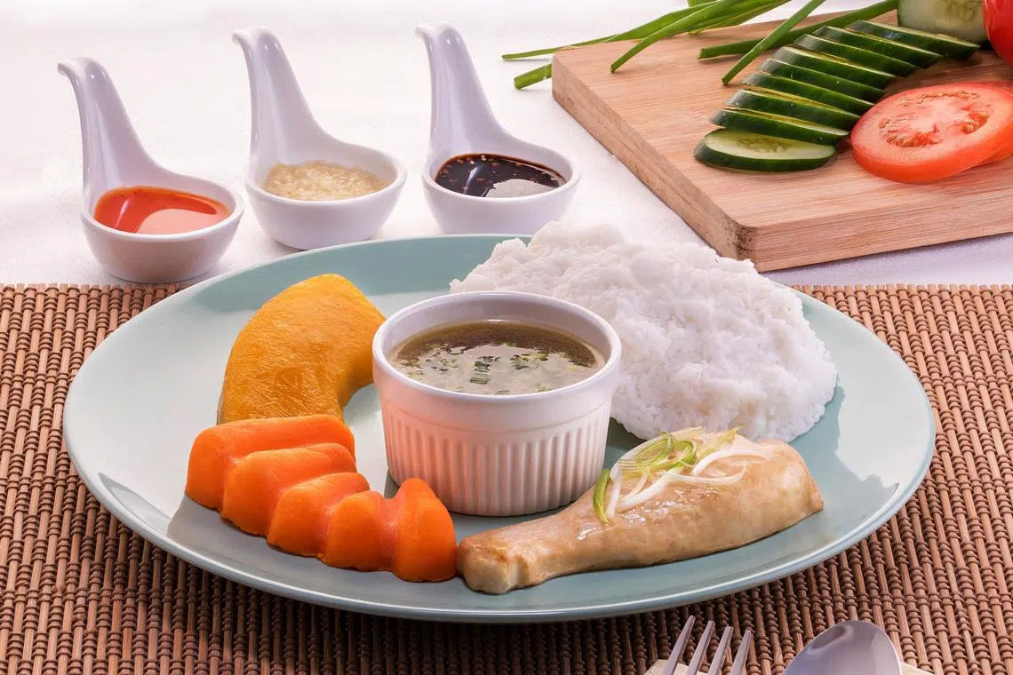 Chicken rice from GentleFoods. The meal comes with rice, a variety of vegetables and soya sauce. It is testing a non-spicy chilli sauce, too. PHOTO COURTESY OF GENTLEFOODS