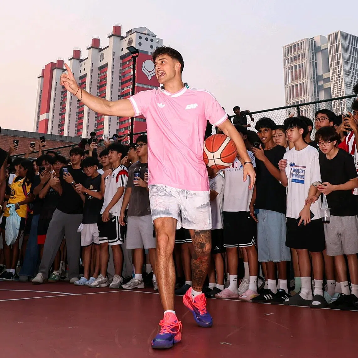 Basketball influencer Matt Kiatipis engaging members of the public at Chinatown Complex basketball court on Oct 6.