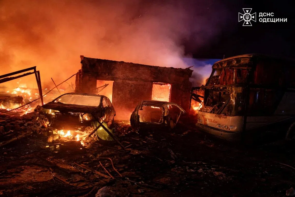 Smoke rises over burning cars and buildings at the site of a vehicles repair workshop hit during overnight Russian drone strikes, amid Russia's attack on Ukraine, in Odesa region, Ukraine April 14, 2026. Press service of the State Emergency Service of Ukraine in Odesa region/Handout via REUTERS