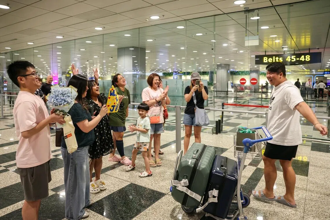 Mr Jason Low (right) was received by eight family members and friends at Changi Airport on March 8.