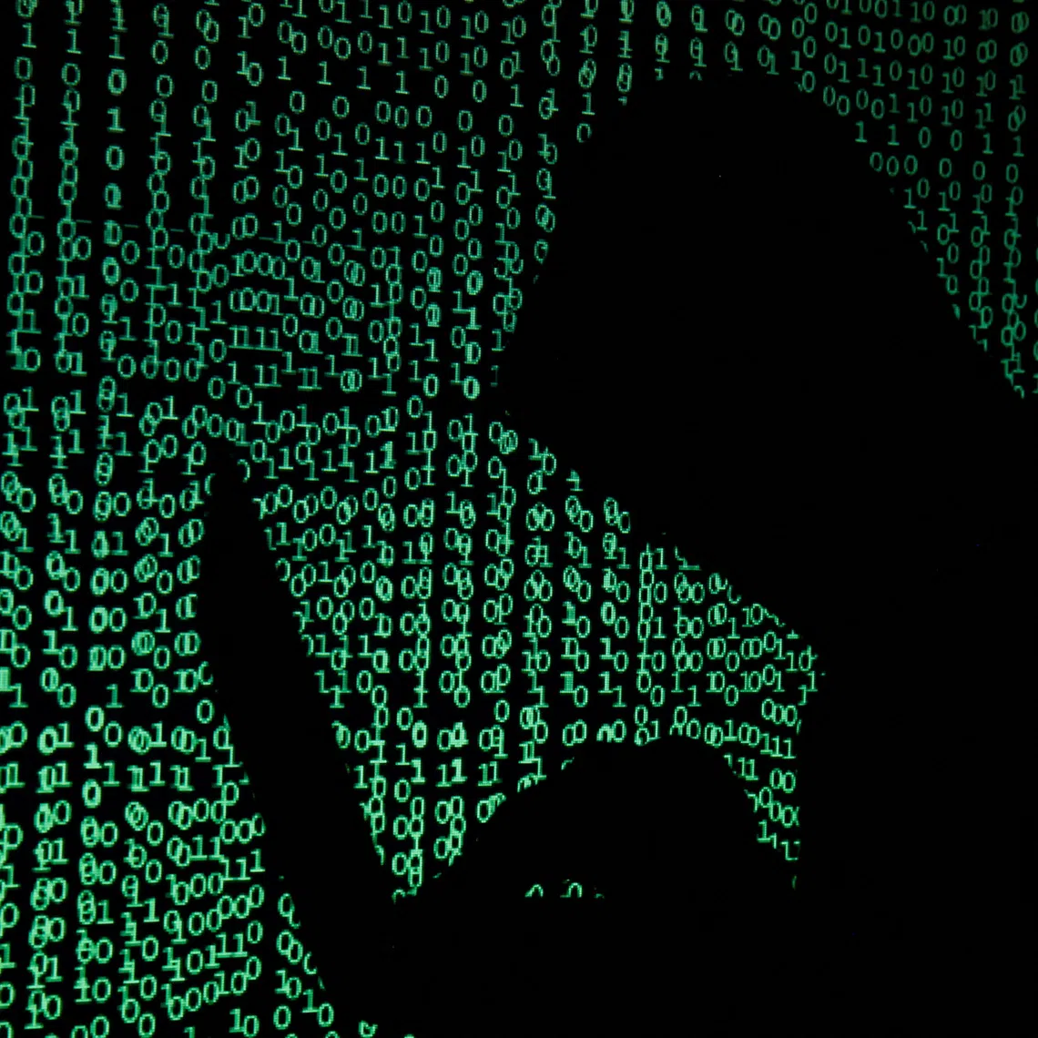 FILE PHOTO: A hooded man holds a laptop computer as cyber code is projected on him in this illustration picture taken on May 13, 2017. REUTERS/Kacper Pempel/Illustration/File Photo