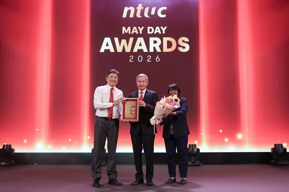 Foreign Minister Vivian Balakrishnan (centre) receiving the Medal of Honour - the labour movement’s top May Day award - from NTUC secretary-general Ng Chee Meng (left) and NTUC president K. Thanaletchimi.