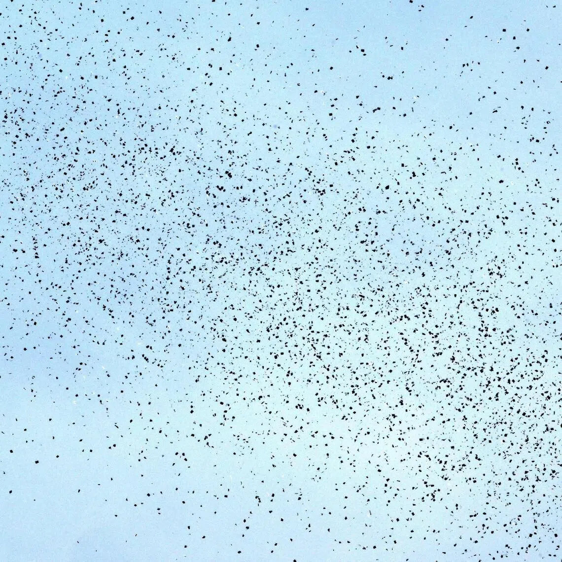 Flyers dropped by Israeli planes are seen scattered across the sky over Beirut on March 13, 2026.