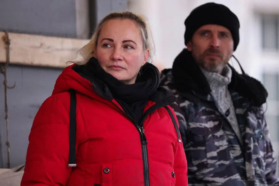 Elena Kolbasnikova and Max Schlund, originally called Rostislav Teslyuk, organisers of pro-Russia rallies, stand on stage at a rally in Cologne, Germany, December 4, 2022. REUTERS/Stringer/File Photo