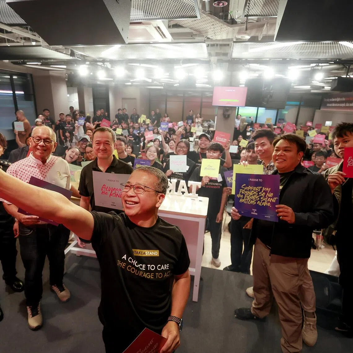 Law Minister Edwin Tong taking a group picture with attendees at the launch of the Take a Stand movement held at The Foundry on Oct 10. 