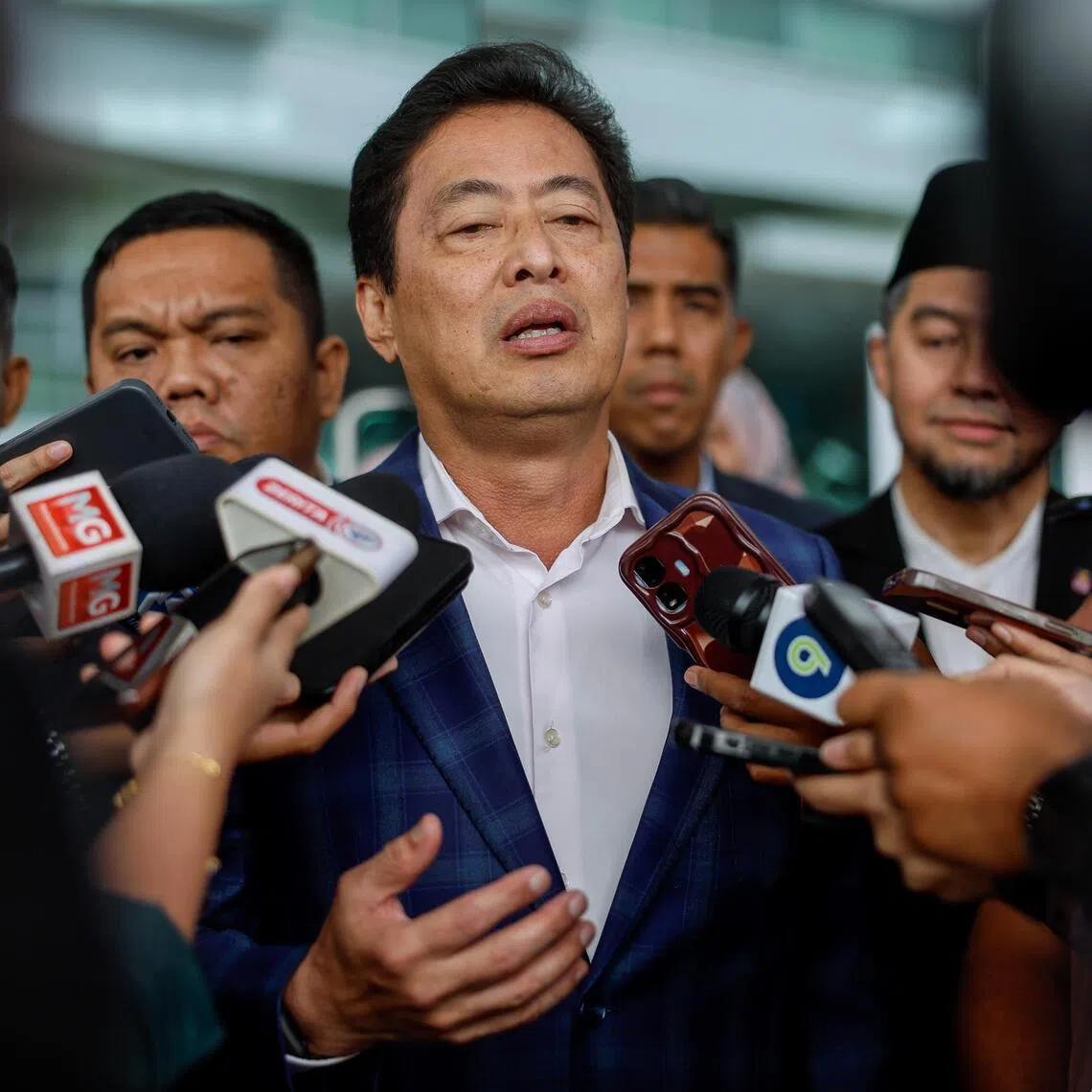 Several government lawmakers are calling for Malaysian anti-graft chief Azam Baki (centre) to be suspended.