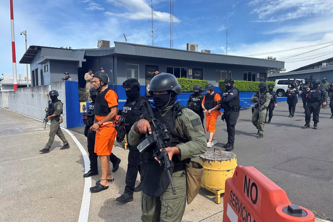 Costa Rican security forces escort alleged drug traffickers Gabriel Lozano, known as \"Compadre,\" and Gilbert Bell Fernandez, known as \"Macho Coca,\" before they are extradited to the United States to stand trial on drug trafficking charges, at Juan Santamaria International Airport in Alajuela, Costa Rica, August 13, 2026. Ministerio de Seguridad Publica/Handout via REUTERS