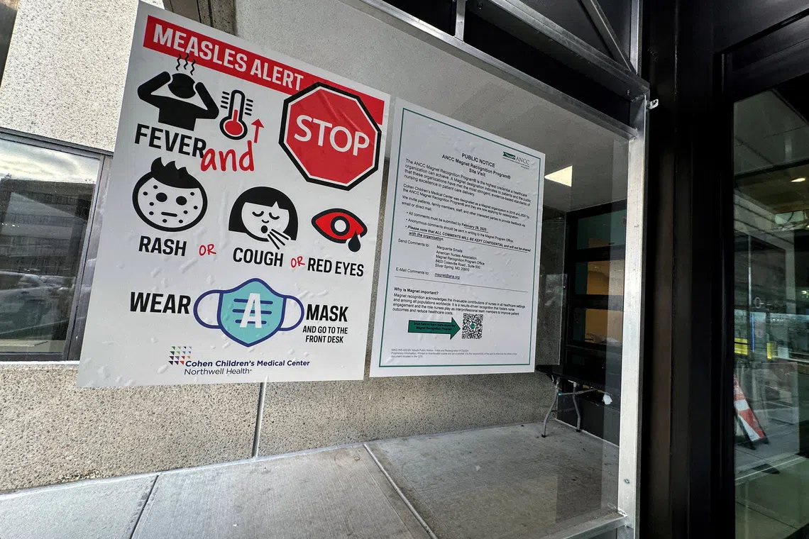 FILE PHOTO: A measles alert sign hangs outside the entrance to the Cohen Children's Medical Center in New Hyde Park, New York, U.S., March 14, 2025. REUTERS/Shannon Stapleton//File Photo