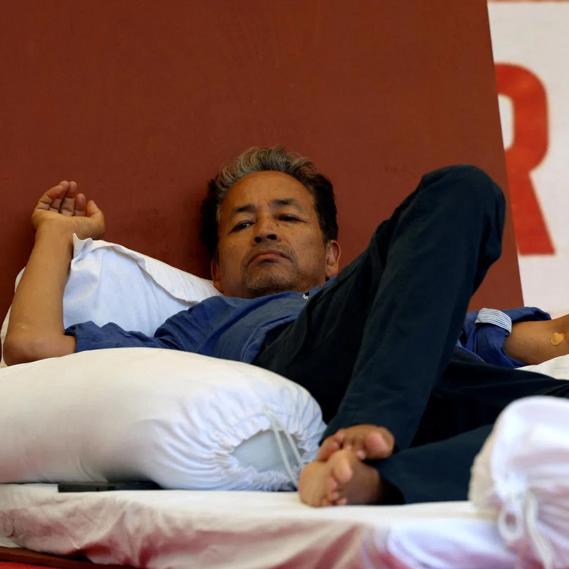Sonam Wangchuk, an Indian education reformer, who has been on hunger strike, rests on stage during a sit-in protest called by CJP demanding the resignation of Indian Education Minister Dharmendra Pradhan, at Jantar Mantar in New Delhi, India, on July 14.