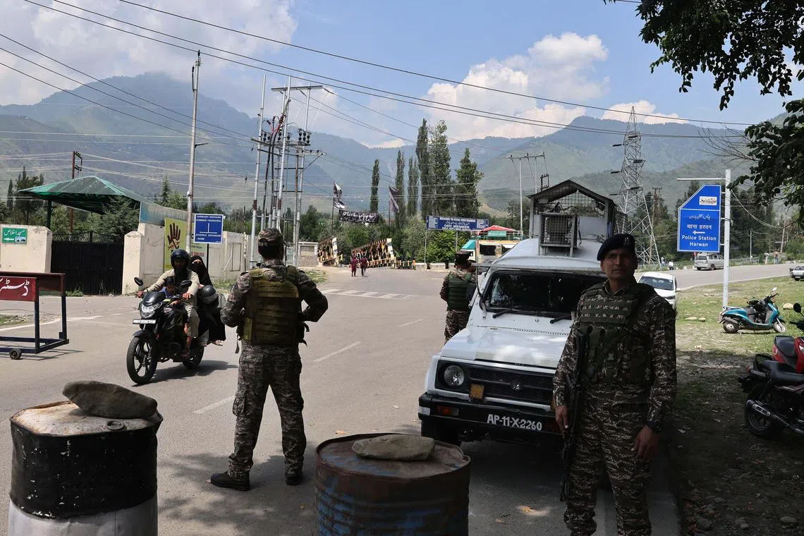 epa12268532 Indian paramilitary soldiers stand guard on a check post near the site of a gunfight on the outskirts of Srinagar, India, 28 July 2025. The Indian Army said that three unidentified militants were killed in an ongoing encounter in the upper reaches of the Harwan-Mulnar area in central Kashmir's Srinagar district.  EPA/FAROOQ KHAN