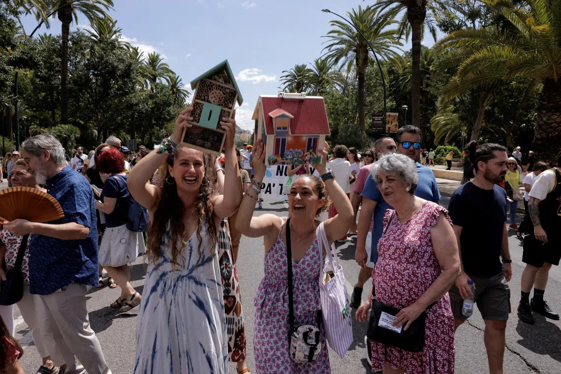 FILE PHOTO: People take part in a demonstration against mass tourism, under the motto \"Malaga to live, not to survive\" in reaction to real estate high prices, driven by the increase of tourist accommodations, in Malaga, Spain, June 29, 2024. REUTERS/Jon Nazca/File Photo
