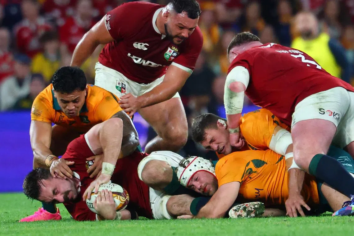 British and Irish Lions' Jack Conan is tackled by Australia's Fraser McReight (on ground) in the first rugby Test match at Suncorp Stadium in Brisbane on July 19, 2025.
