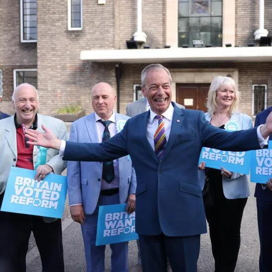 Reform Party leader Nigel Farage (centre) arrives at Havering Town Hall in London, Britain, on May 8, 2026.