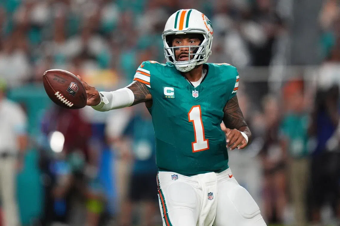 FILE PHOTO: Sep 12, 2024; Miami Gardens, Florida, USA; Miami Dolphins quarterback Tua Tagovailoa (1) tosses the ball during the first half against the Buffalo Bills at Hard Rock Stadium. Mandatory Credit: Jasen Vinlove-Imagn Images/File Photo