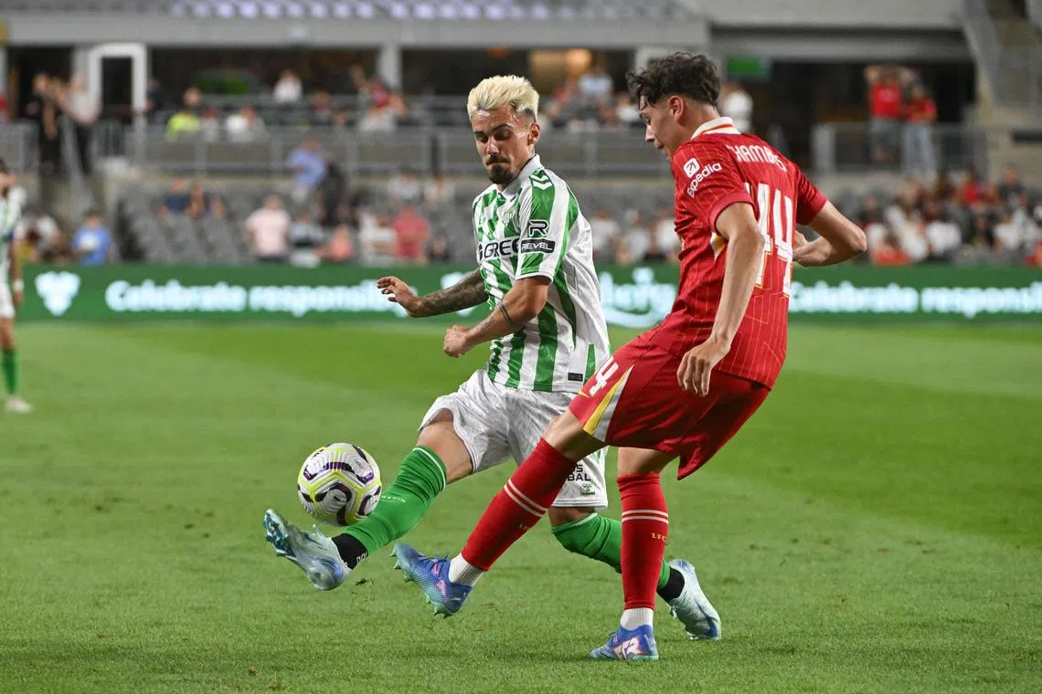 Jul 26, 2024; Pittsburgh, PA, USA; Real Betis midfielder Rodri (17) kicks the ball against Liverpool defender Luke Chambers during the second half at Acrisure Stadium. Mandatory Credit: Barry Reeger-USA TODAY Sports