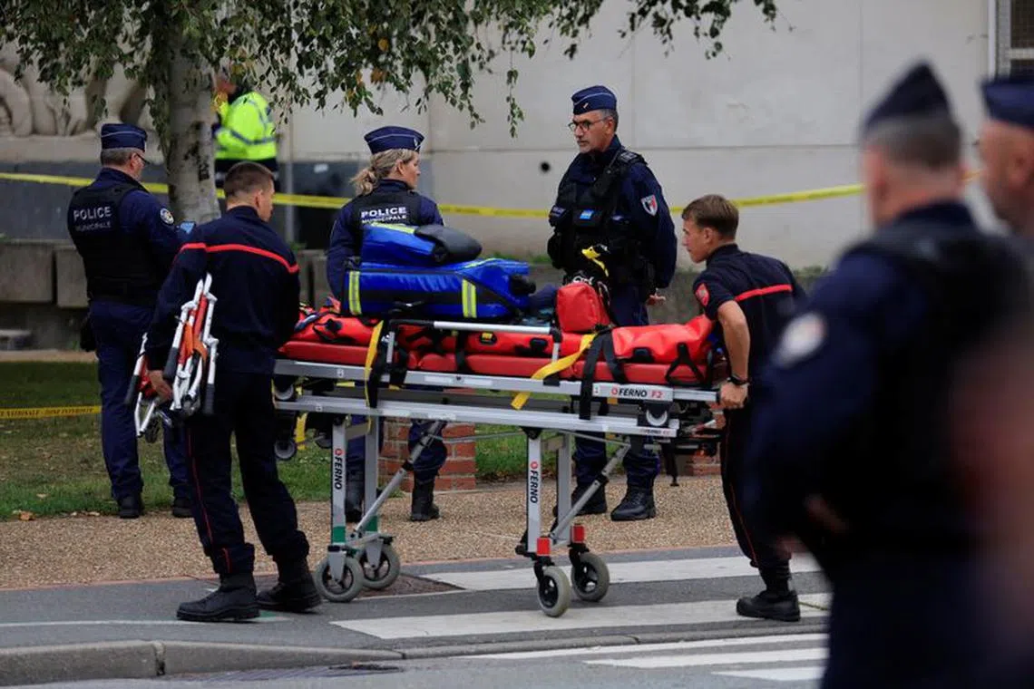 French police and rescue workers work at the site after a teacher was killed and several people injured in a knife attack at the Lycee Gambetta-Carnot high school in Arras, northern France, October 13, 2023. REUTERS/Pascal Rossignol