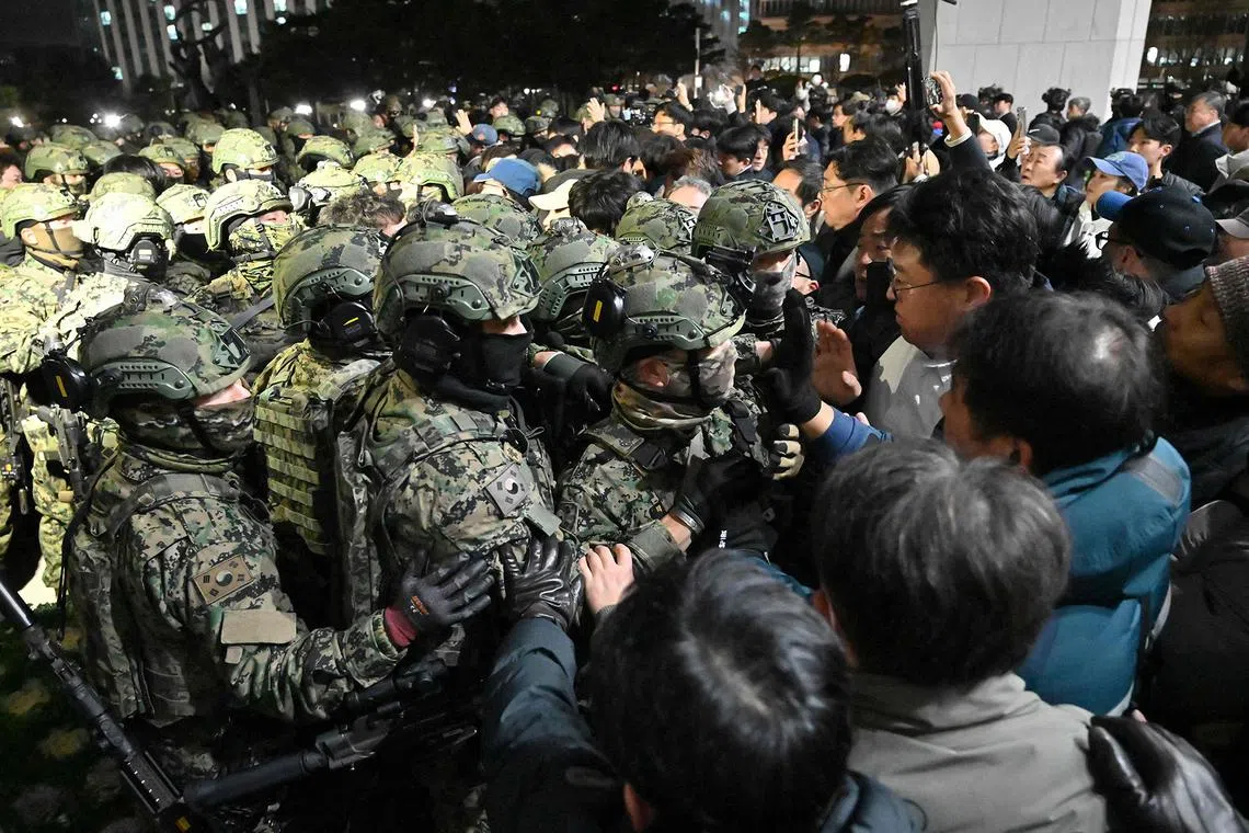Soldiers trying to enter the National Assembly building in Seoul on Dec 4 2024, after South Korea President Yoon Suk Yeol declared martial law the night before. 