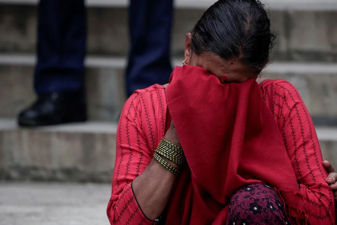 FILE PHOTO: A family member of the victim reacts outside a hospital after a Saurya Airlines plane caught fire after skidding off the runway while taking off at Tribhuvan International Airport, in Kathmandu, Nepal, July 24, 2024. REUTERS/Navesh Chitrakar/File Photo