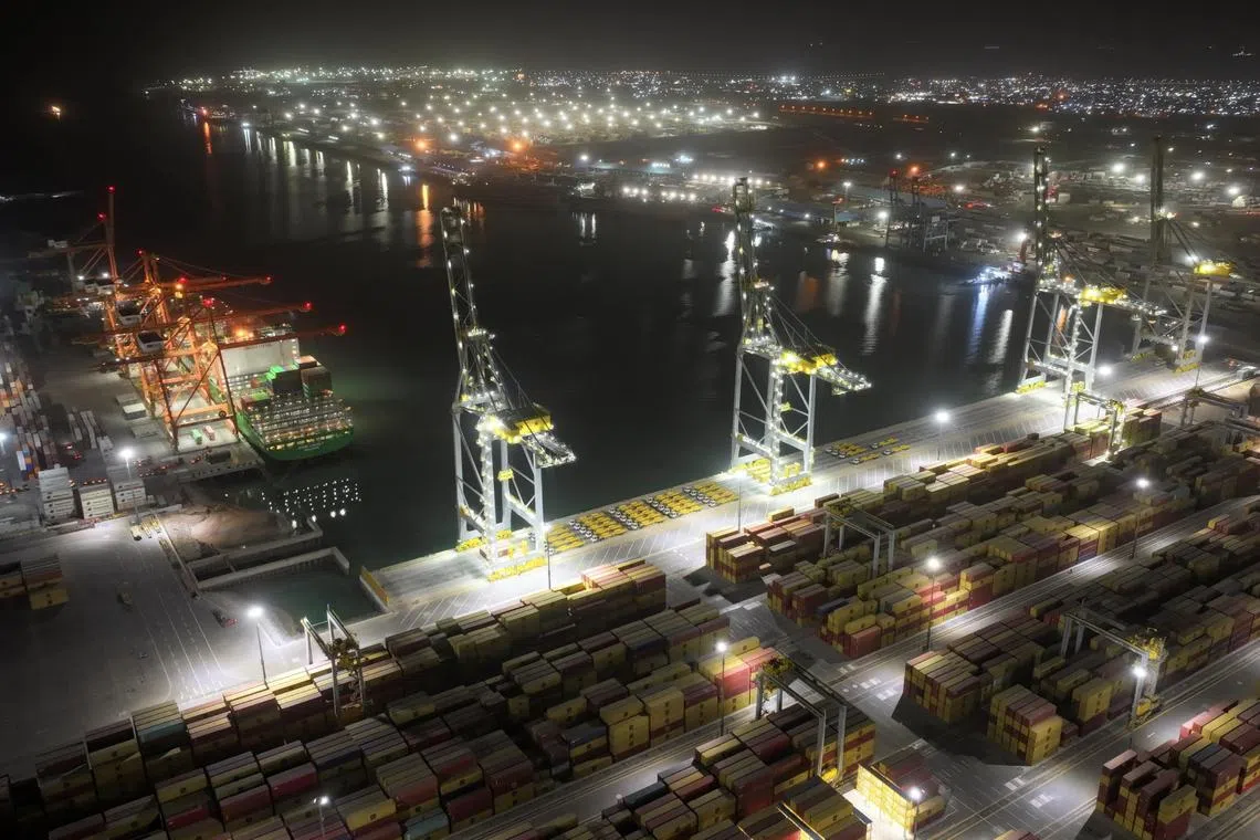 A drone view of an Evergreen container ship docked at the port of Umm Qasr during nighttime operations in Basra, Iraq.