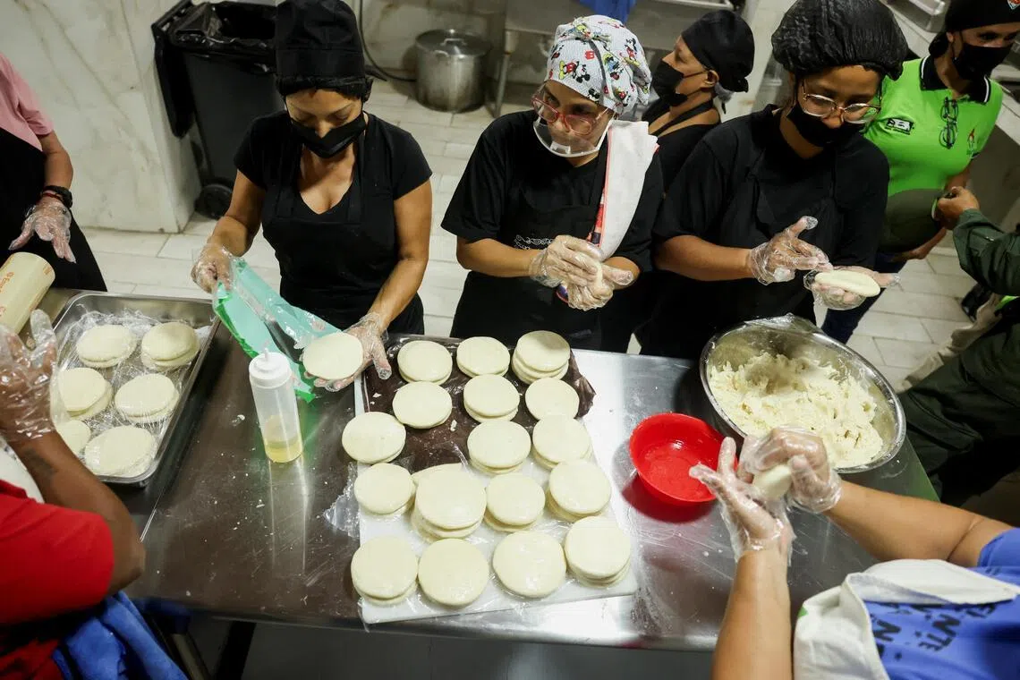 Volunteers prepare food at a makeshift shelter inside a school in the Artigas neighbourhood of Caracas, Venezuela.