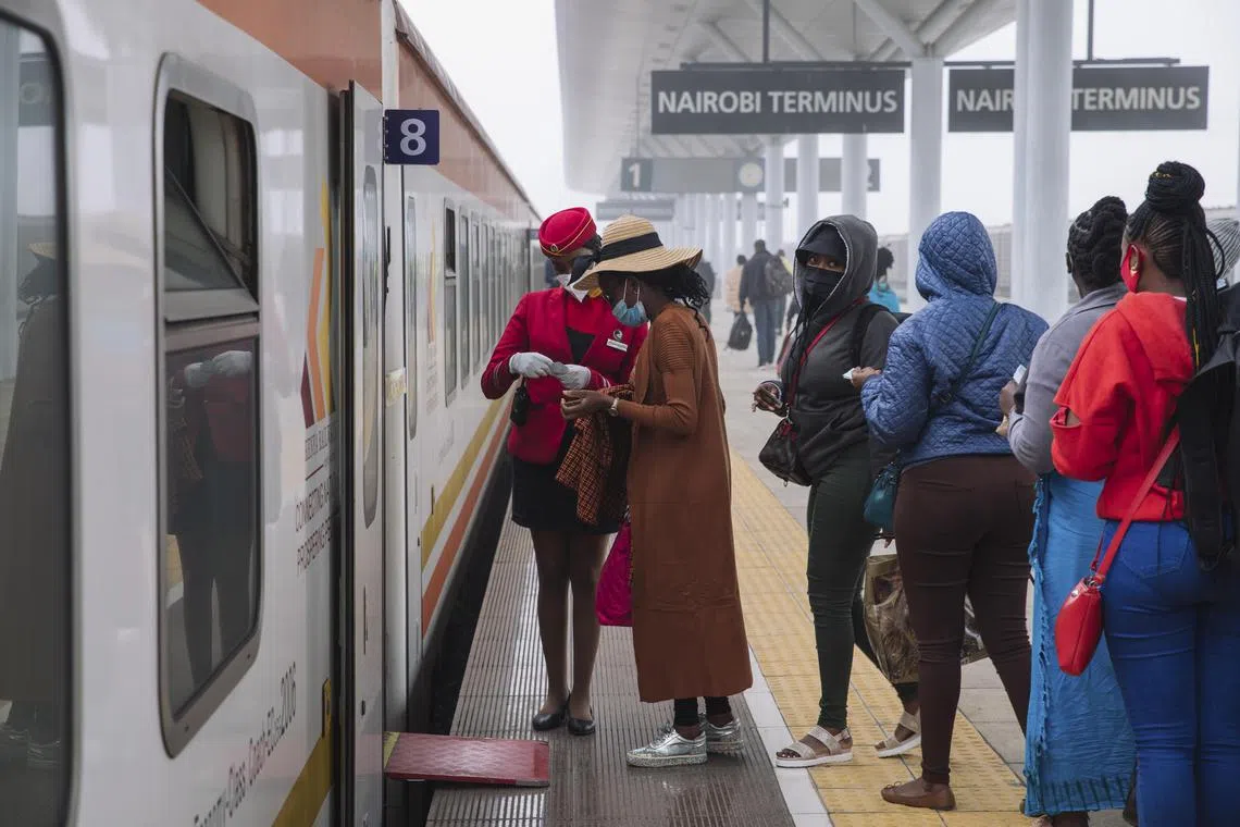 **EMBARGO: No electronic distribution, Web posting or street sales before MONDAY 03:01 A.M. ET DEC. 12, 2022. No exceptions for any reasons. EMBARGO set by source.** FILE — Passengers boarding a Chinese-built train in Nairobi, Kenya, on Aug. 13, 2021. China, Russia, Turkey and the United Arab Emirates are all vying for influence in Africa; on Tuesday the U.S.-Africa Leaders Summit starts in Washington. (Sarah Waiswa/The New York Times)
