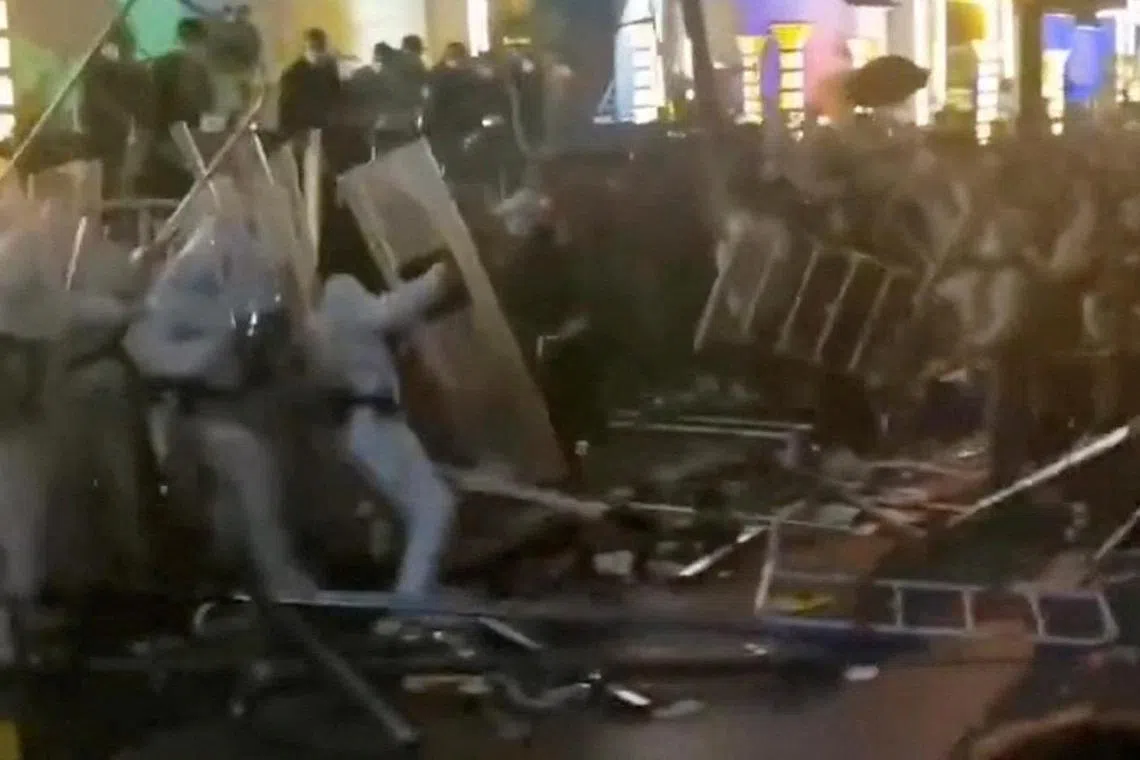 Security forces clash with workers during a protest outside Apple supplier Foxconn's factory in Zhengzhou, China on Nov 23, 2022.