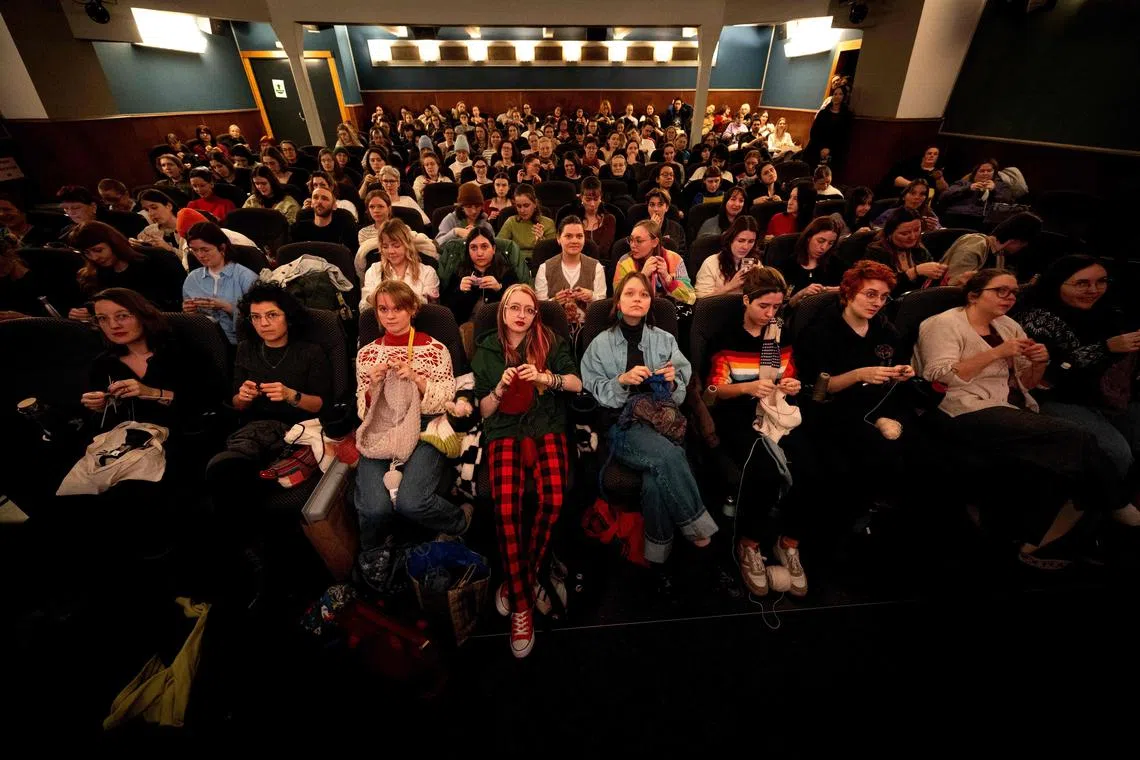 This general overview shows visitors enjoying their knitting during the projection of the movie 'The Devil Wears Prada' at the Votive Cinema in Vienna, Austria, on February 16, 2025. 