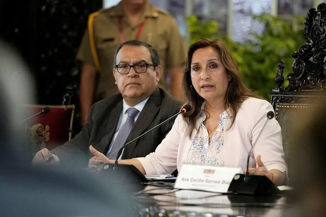FILE PHOTO: Peru's President Dina Boluarte, flanked by Prime Minister Alberto Otarola, addresses the media, in Lima, Peru December 29, 2022. REUTERS/Angela Ponce/File Photo