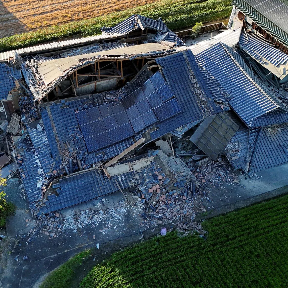 A drone view of a collapsed house in the aftermath of an earthquake with a preliminary magnitude of 7.1 that struck Japan’s southern Kumamoto prefecture on July 28.
