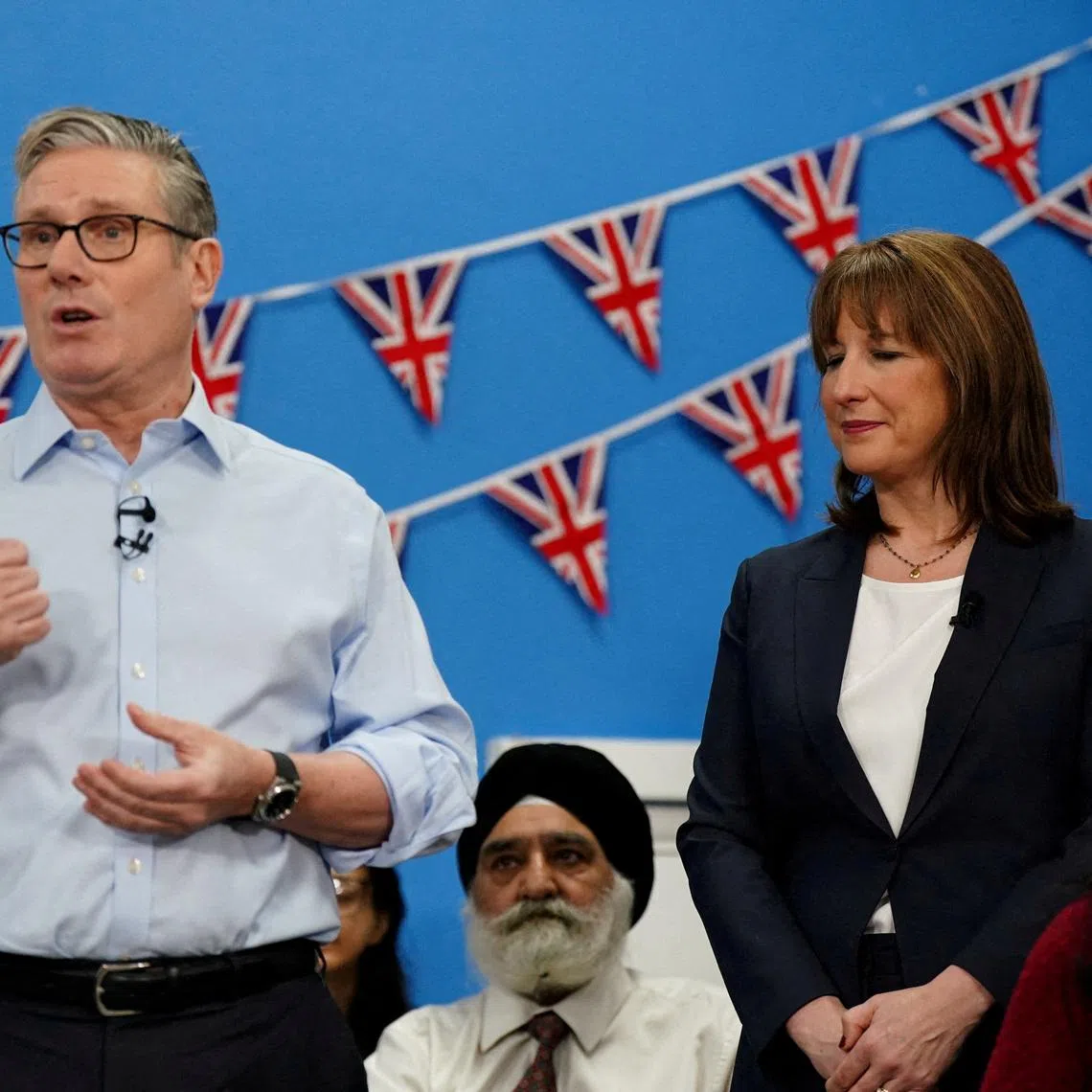 FILE PHOTO: Britain's Chancellor of the Exchequer Rachel Reeves stands next to Prime Minister Keir Starmer in Rugby, Warwickshire, Britain, November 27, 2025.    Jacob King/Pool via REUTERS/File Photo