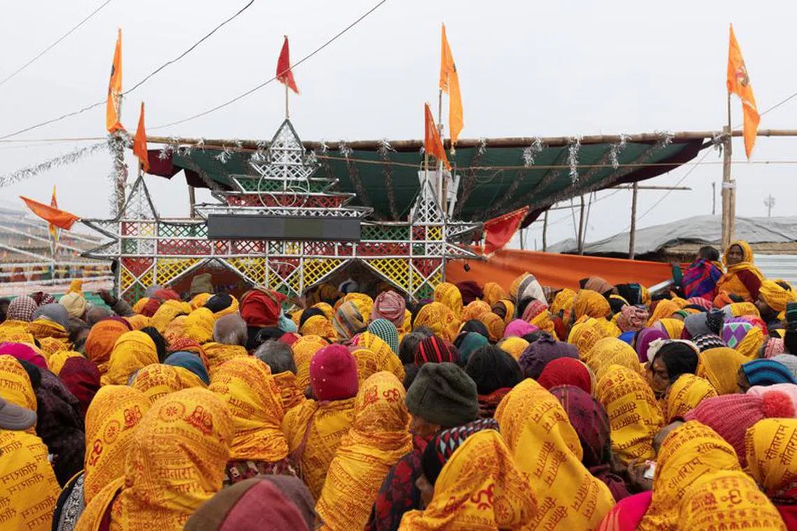 Hindu devotees wait to collect free blankets at the tent city built for the pilgrims on the banks of the Sarayu river ahead of the opening of the temple of Lord Ram in Ayodhya, India, January 20, 2024. REUTERS/Adnan Abidi