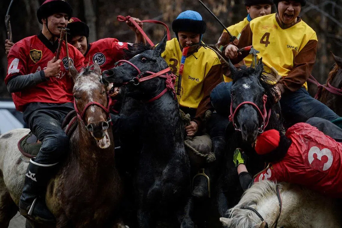 Horsemen play Kokpar, a traditional game between two teams competing to throw a dummy of a goat into a scoring circle, during the championship in Almaty, Kazakhstan, Nov 5, 2022. 