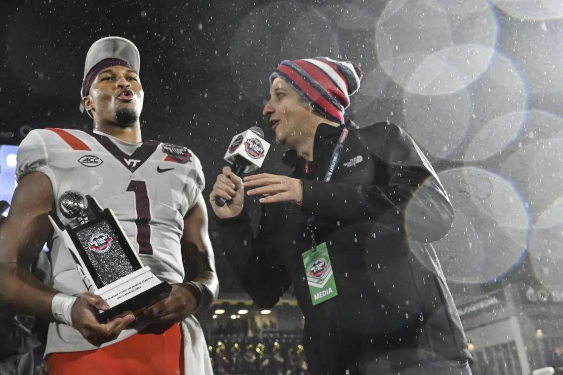 FILE PHOTO: Dec 27, 2023; Annapolis, MD, USA;  Virginia Tech Hokies quarterback Kyron Drones (1) reacts during a post game interview after being award the game MVP  after the game against the Tulane Green Wave at Navy-Marine Corps Memorial Stadium. Mandatory Credit: Tommy Gilligan-USA TODAY Sports/File Photo