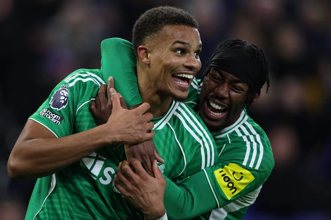 Newcastle United defender Malick Thiaw celebrates scoring his team's fourth goal with midfielder Anthony Elanga.