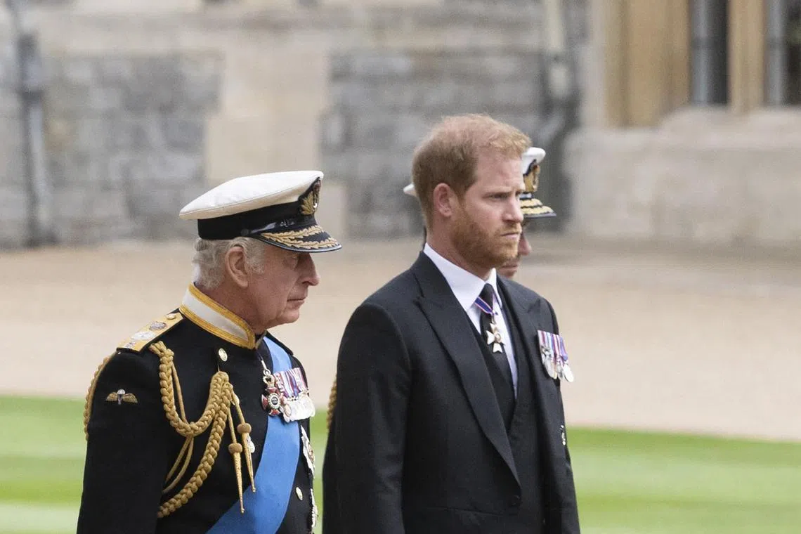 Britain's King Charles (left) walks with his son Prince Harry inside Windsor Castle on Sept 19, 2022.