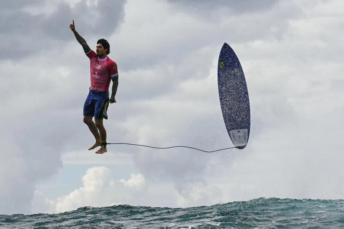 Brazilian surfer Gabriel Medina reacts after getting a large wave in the fifth heat of the men's surfing round three, during the Paris 2024 Olympic Games, in Teahupo'o on July 29.