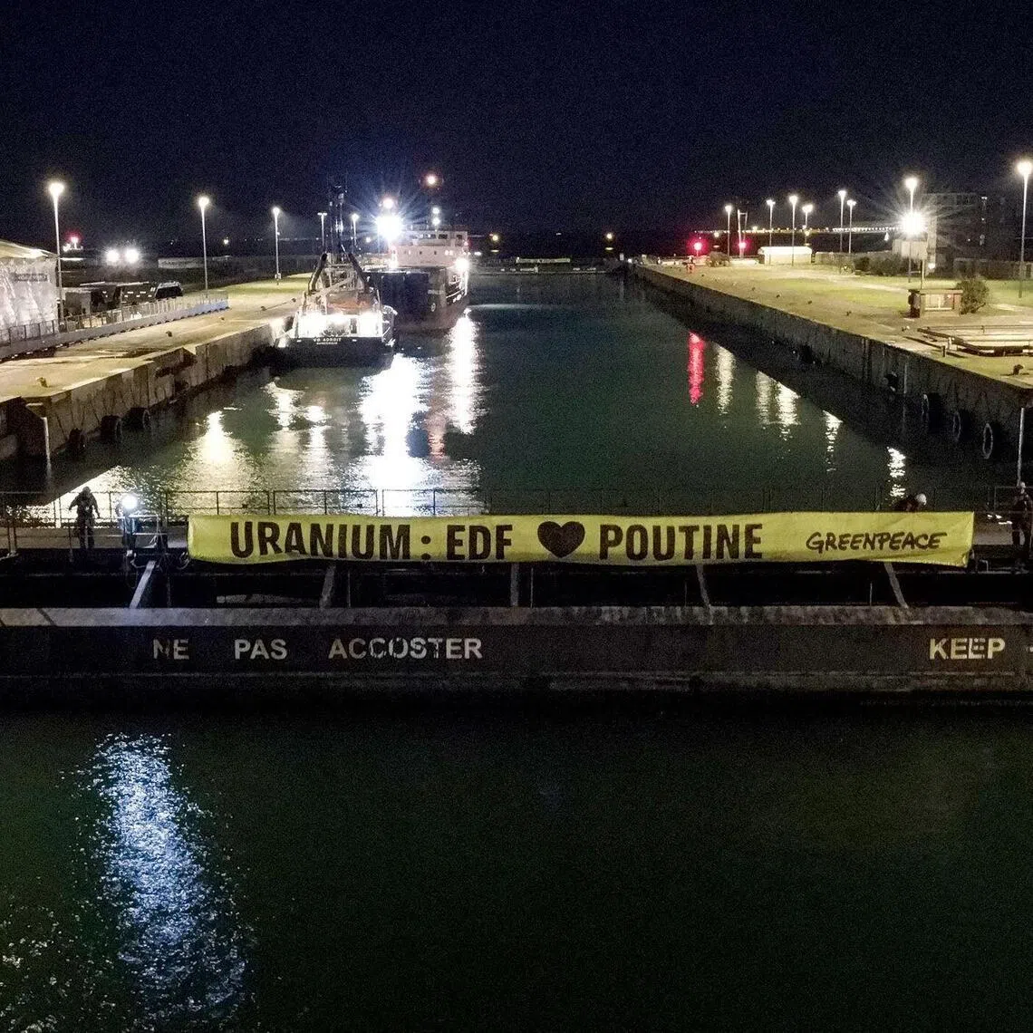 A banner reading "Uranium : EDF 'loves' Putin" hung by Greepeace activists blocaded the Mikhail Dudin at the northern port of Dunkirk on the morning of March 2.