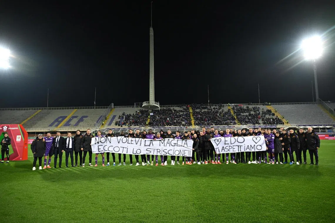 Fiorentina players show a banner in support of their teammate Edoardo Bove after the Italia Cup match against Empoli.