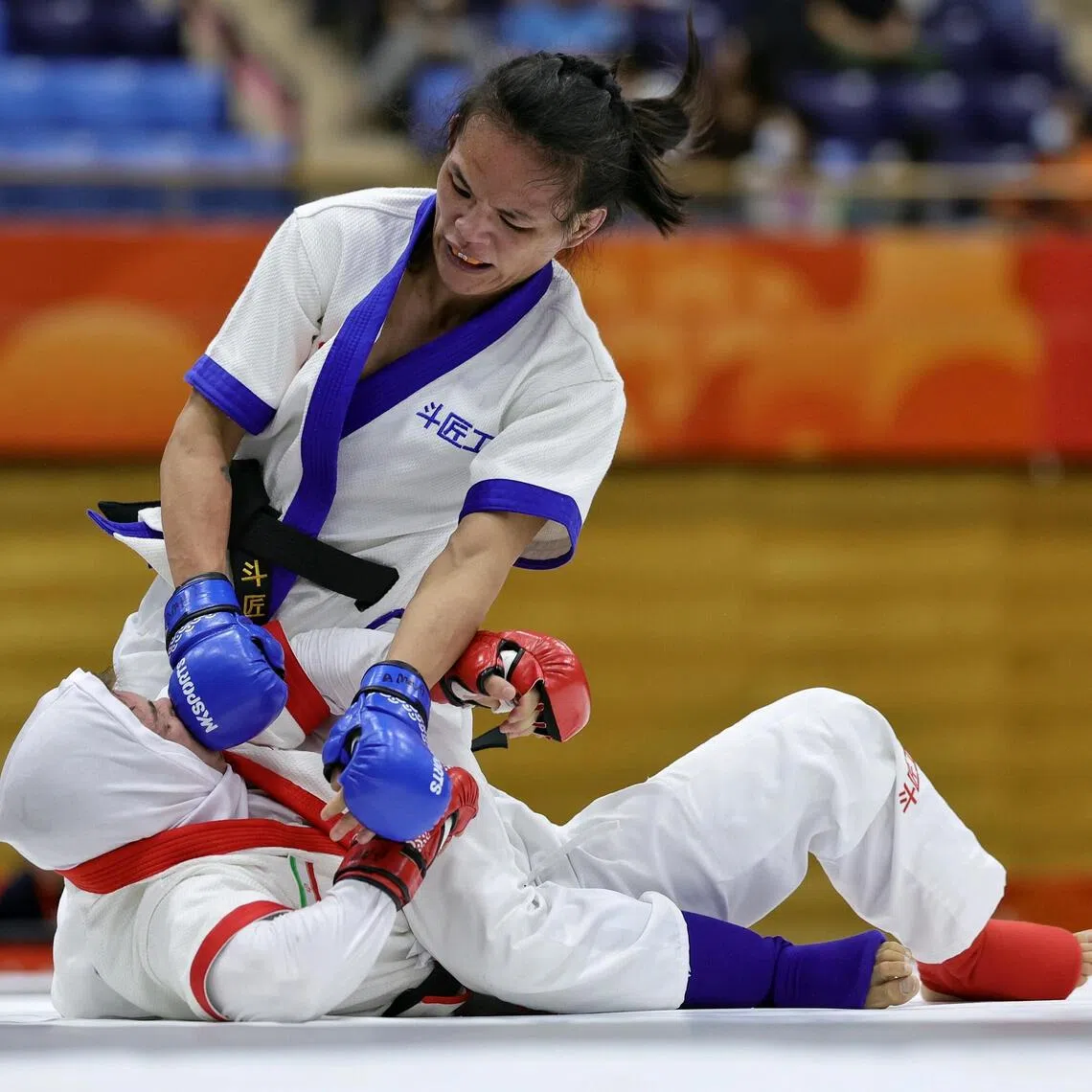 Tiffany Teo of Singapore delivering a flurry of headshots to Arezou Salimighalehtaki of Iran at the Asian Games on Sept 20.