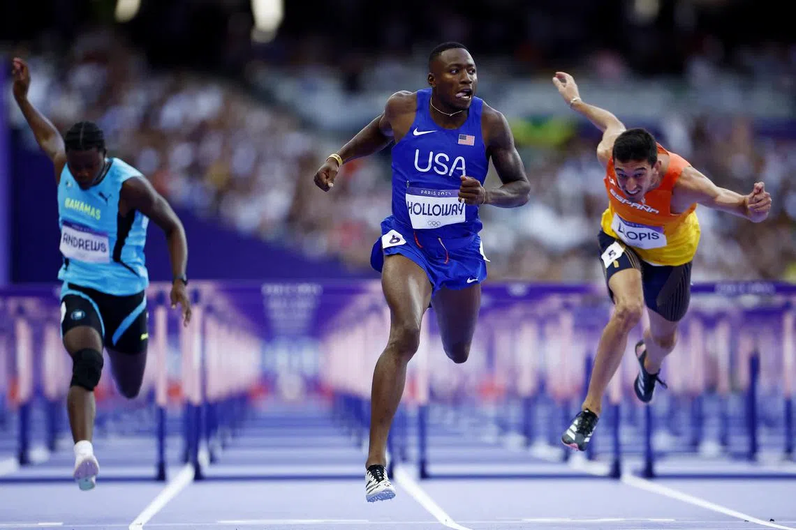 Paris 2024 Olympics - Athletics - Men's 110m Hurdles Semi-Finals - Stade de France, Saint-Denis, France - August 07, 2024.
Grant Holloway of United States crosses the line to win semi final 1 ahead of second placed Enrique Llopis of Spain. REUTERS/Sarah Meyssonnier